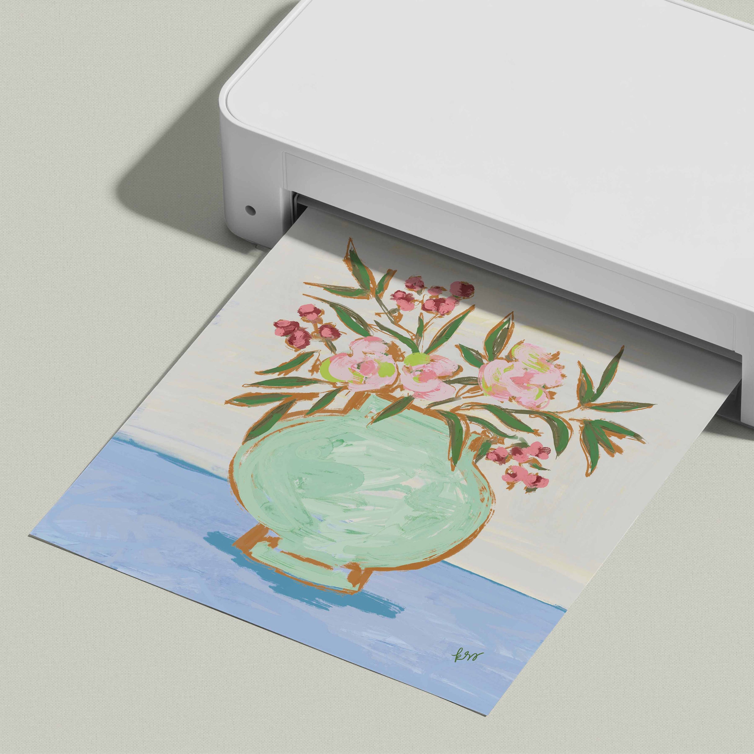 A white printer is displaying a colorful painting of a vase with flowers on a light blue background.