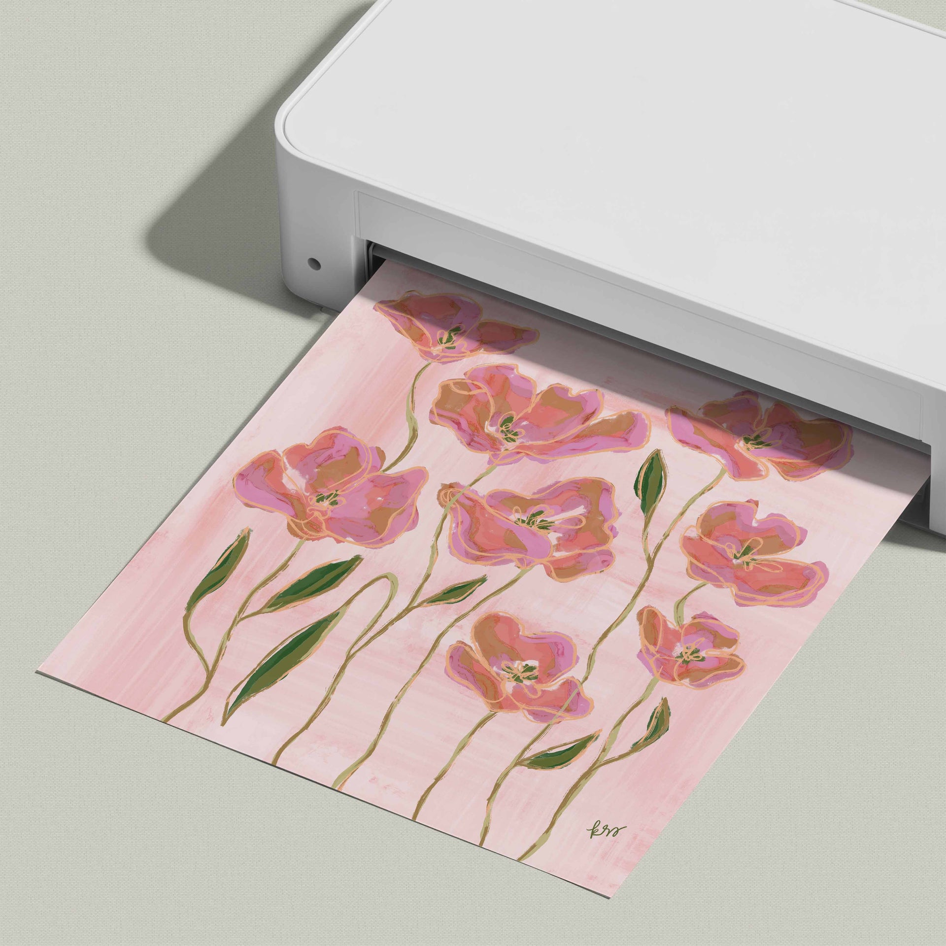 A white printer is displaying a printed image of pink flowers on a pink background.