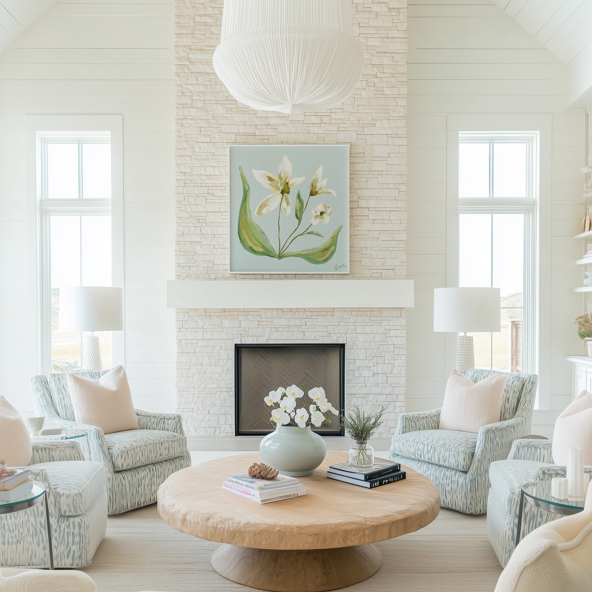 a cozy living room with a fireplace, a large painting of flowers on the wall, and a wooden coffee table with a vase of flowers. The room is furnished with two armchairs and a sofa, and there are two lamps providing soft lighting. The overall atmosphere of the room is warm and inviting, with a harmonious color scheme and a well-designed layout.