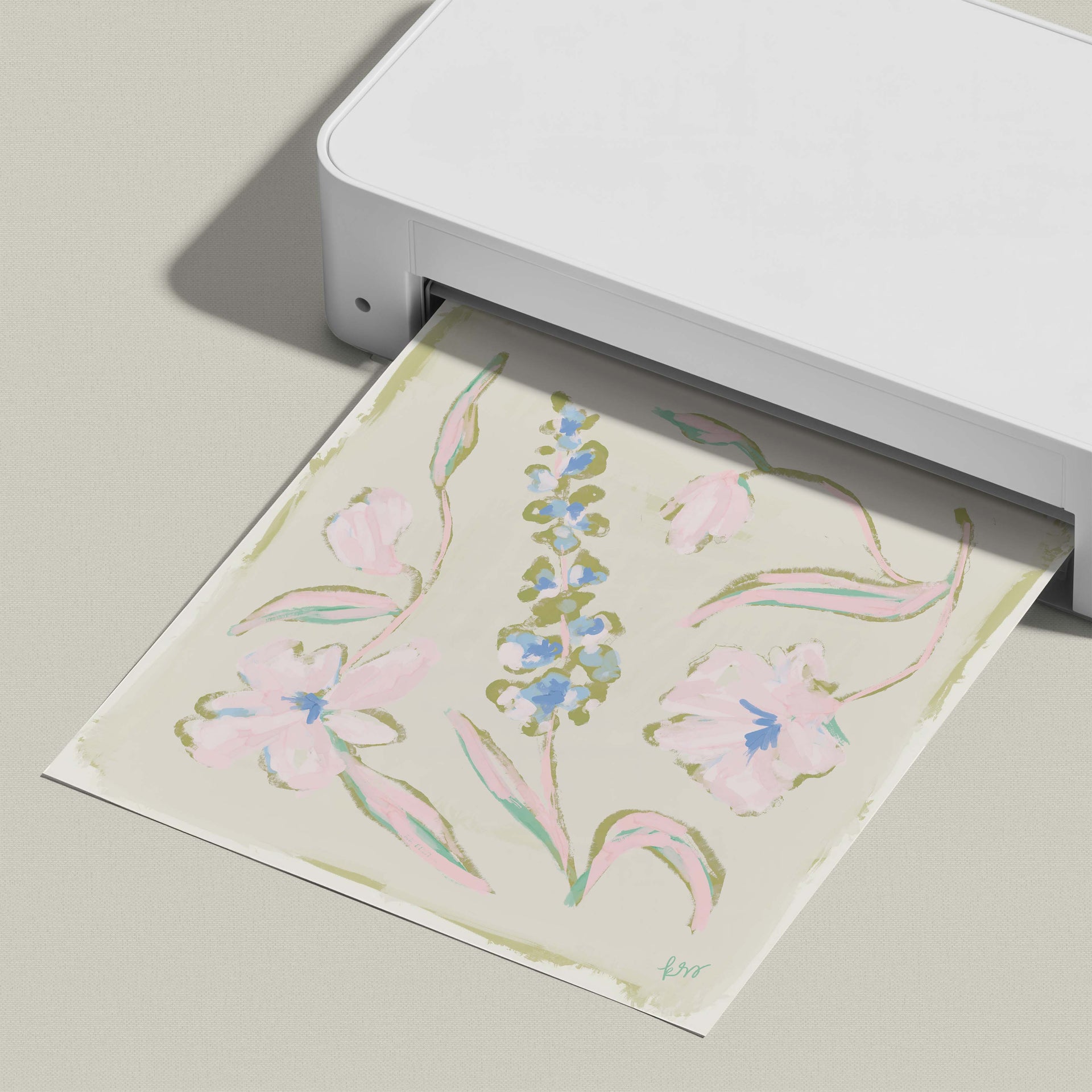 A white printer is printing a floral design on a piece of paper.