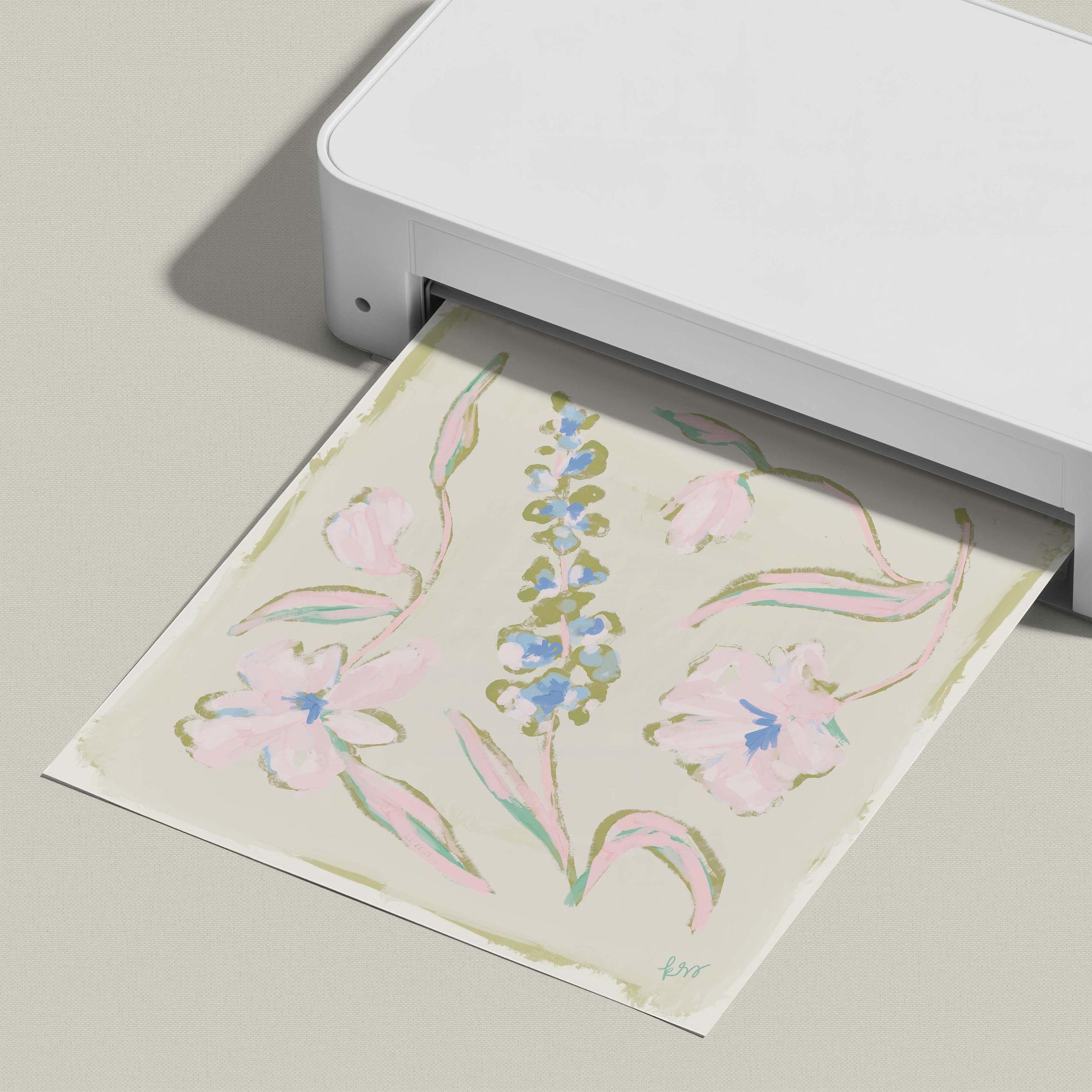 A white printer is printing a floral design on a piece of paper.