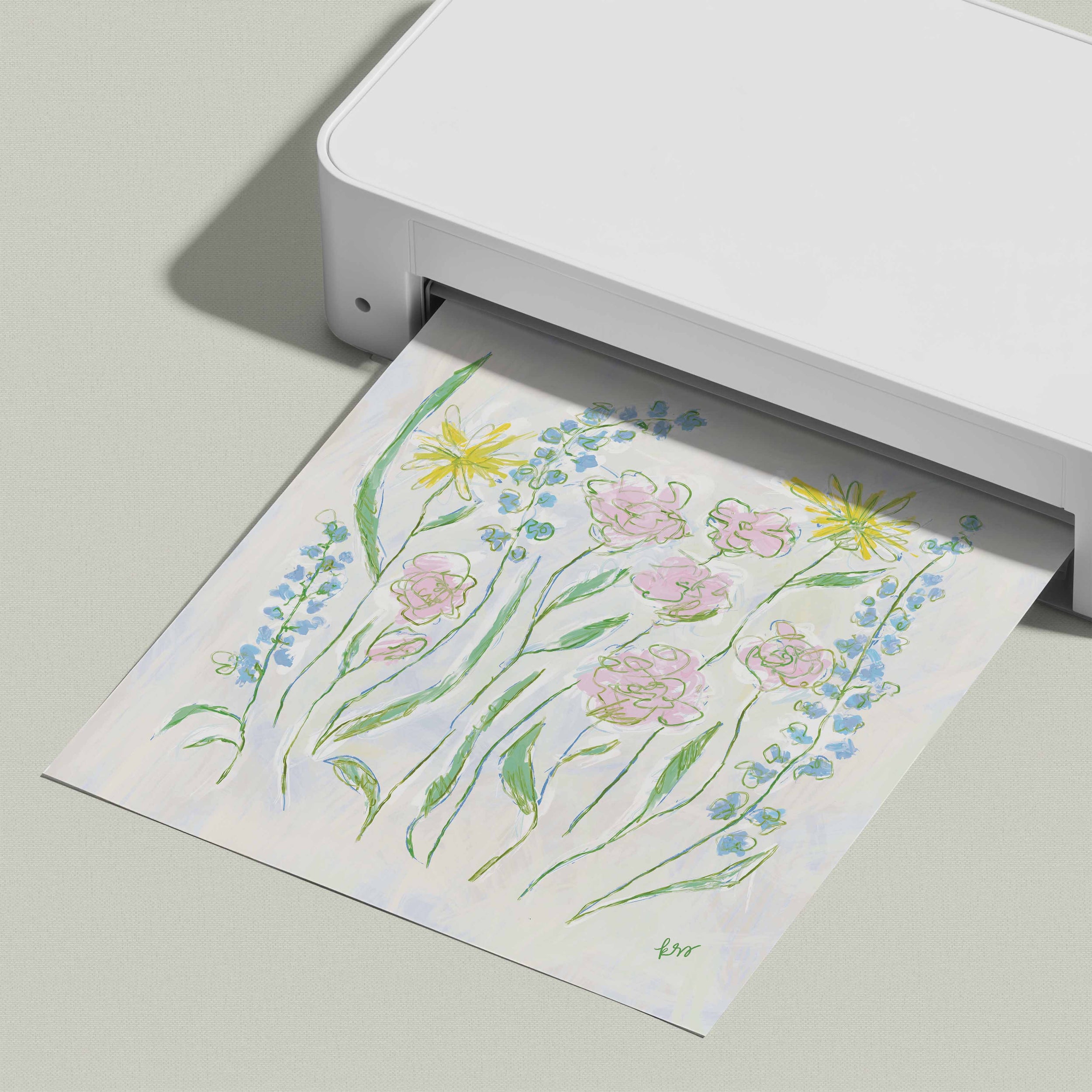 A white printer is displaying a colorful printed paper with a floral design.