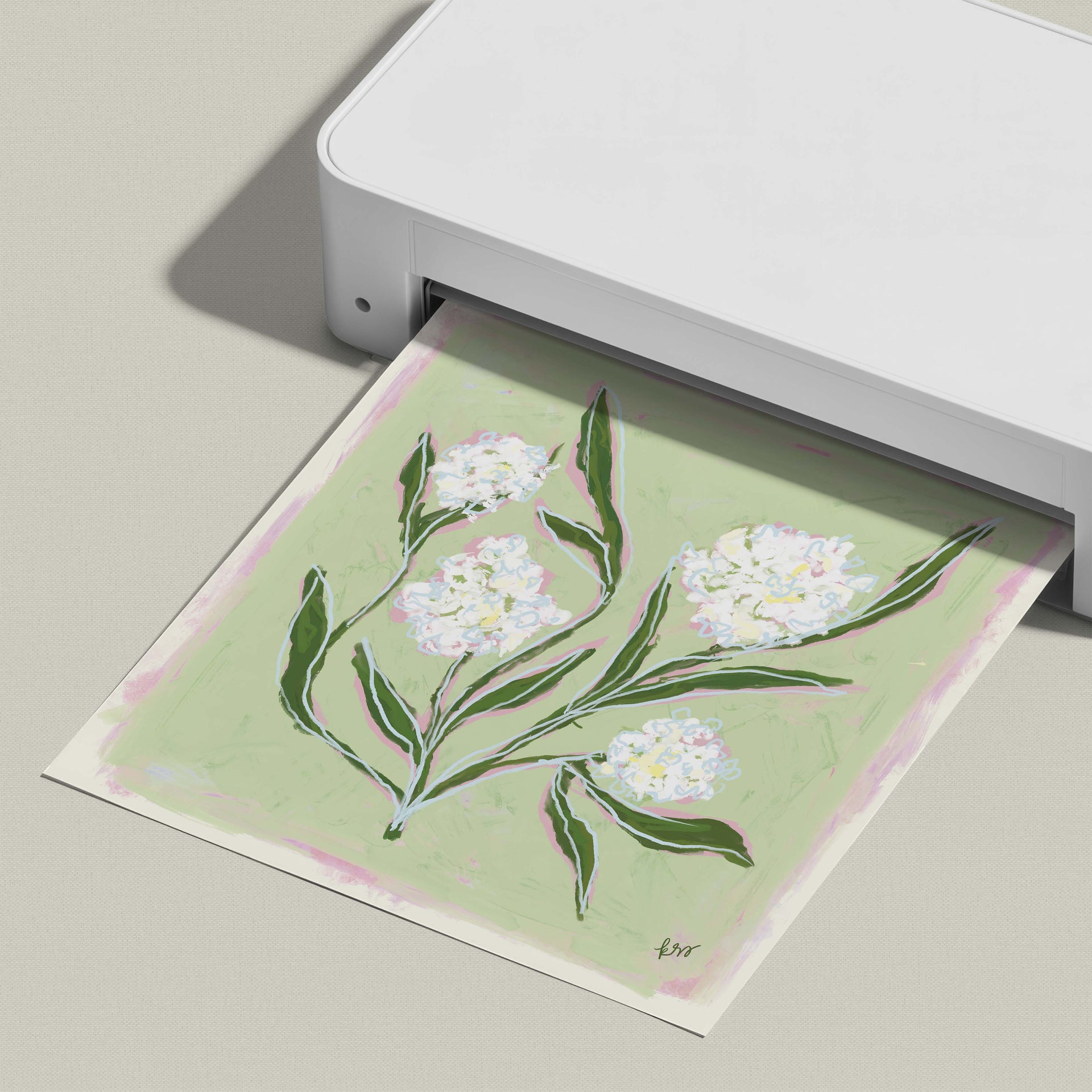 A white printer is printing a picture of white flowers on a green background.