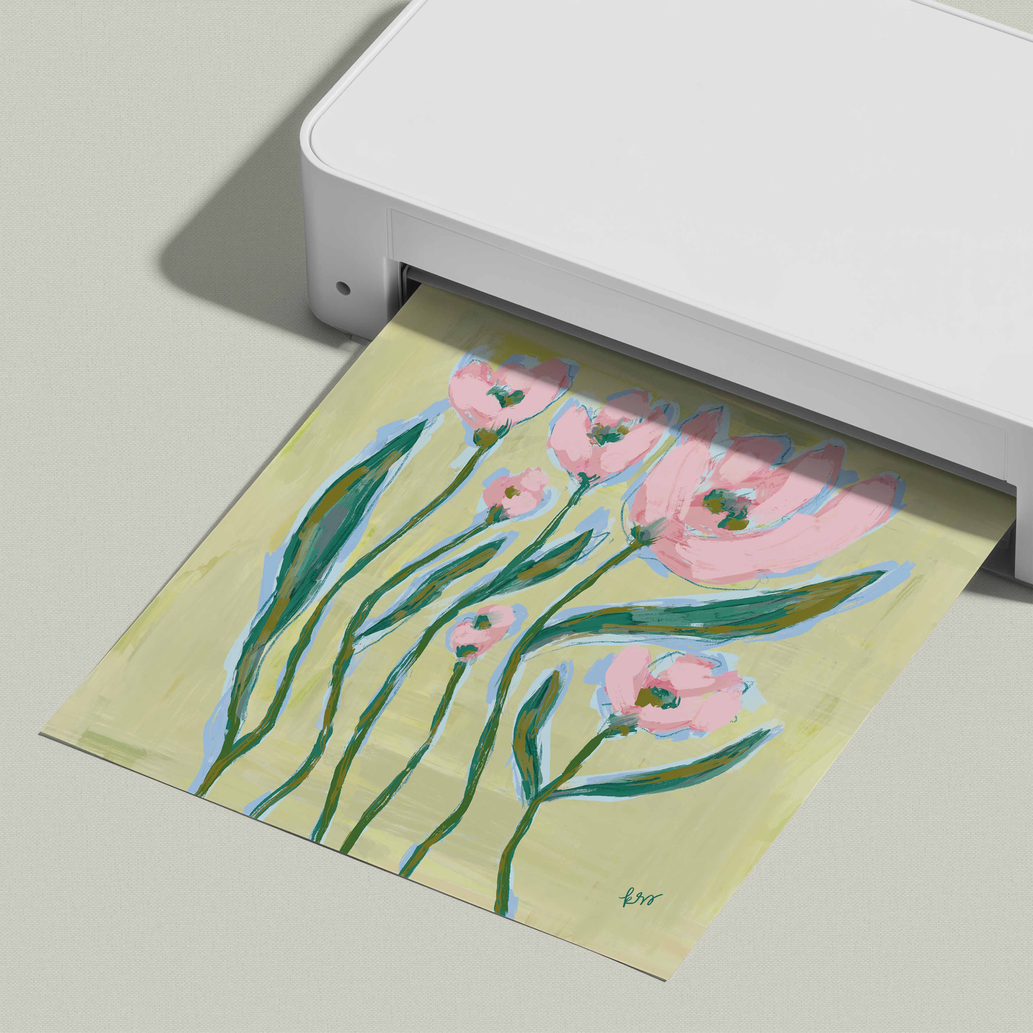 A white printer is printing a colorful painting of pink flowers on a yellow background.