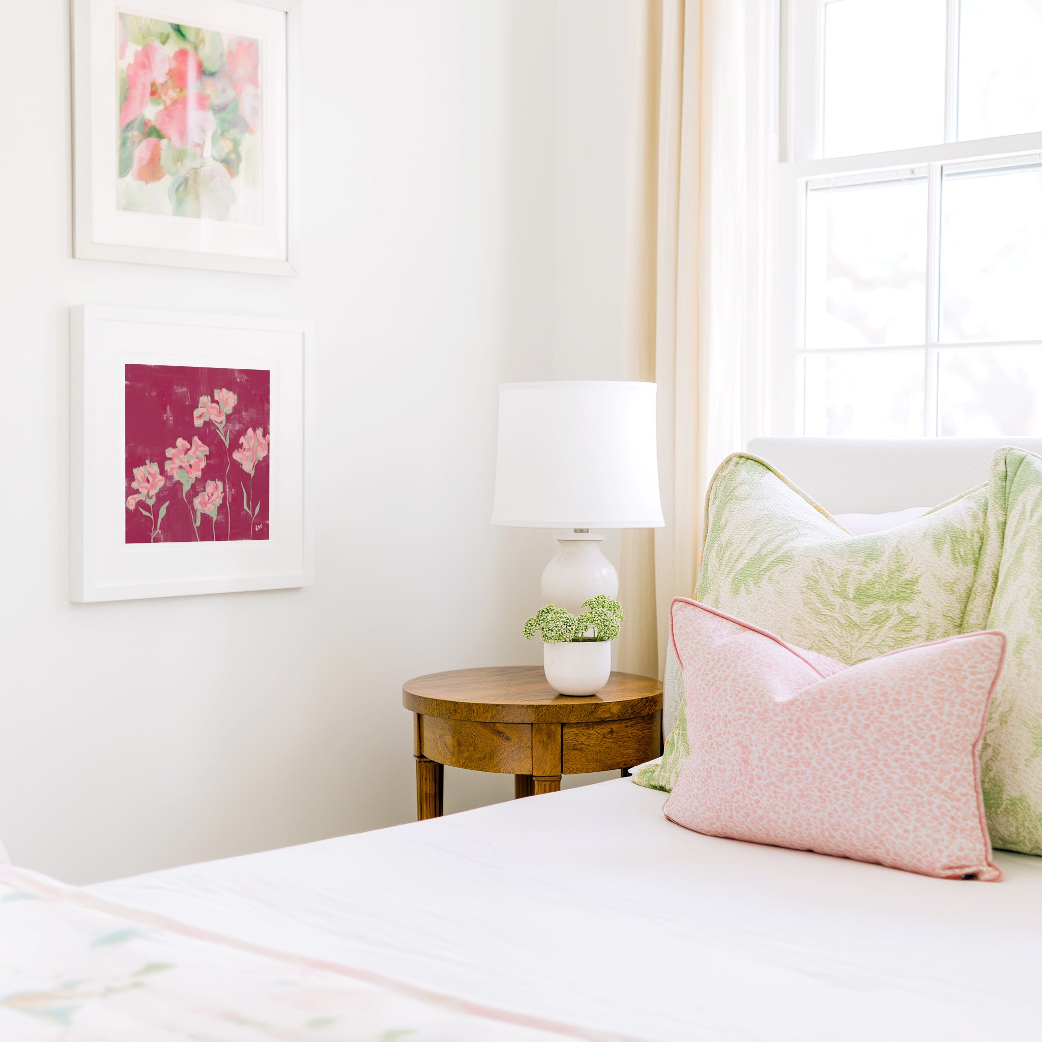 a cozy bedroom corner with a bed, a wooden nightstand, and a framed artwork on the wall.