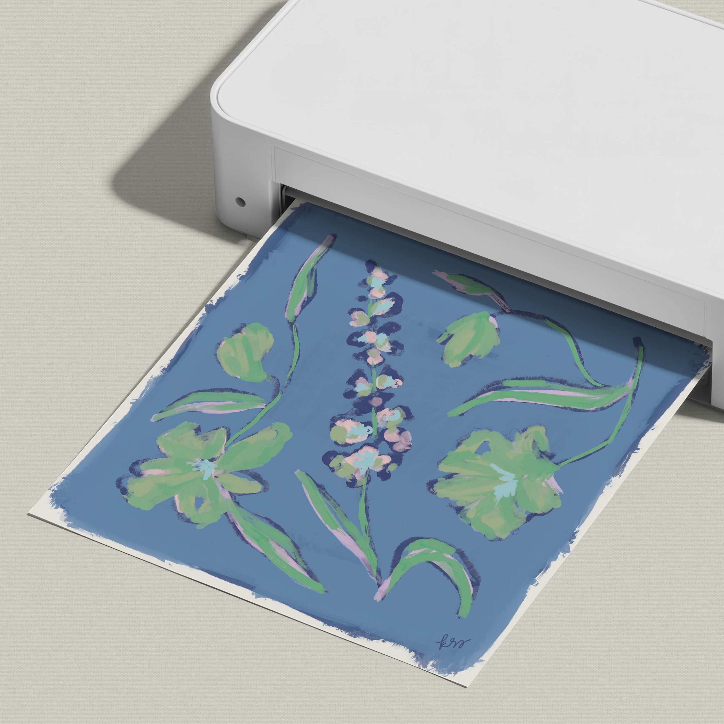 A printer is printing a colorful floral design on a blue background.