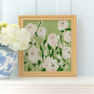 a framed painting of white and green flowers on a white shelf, with a blue and white vase of white hydrangeas placed next to it.