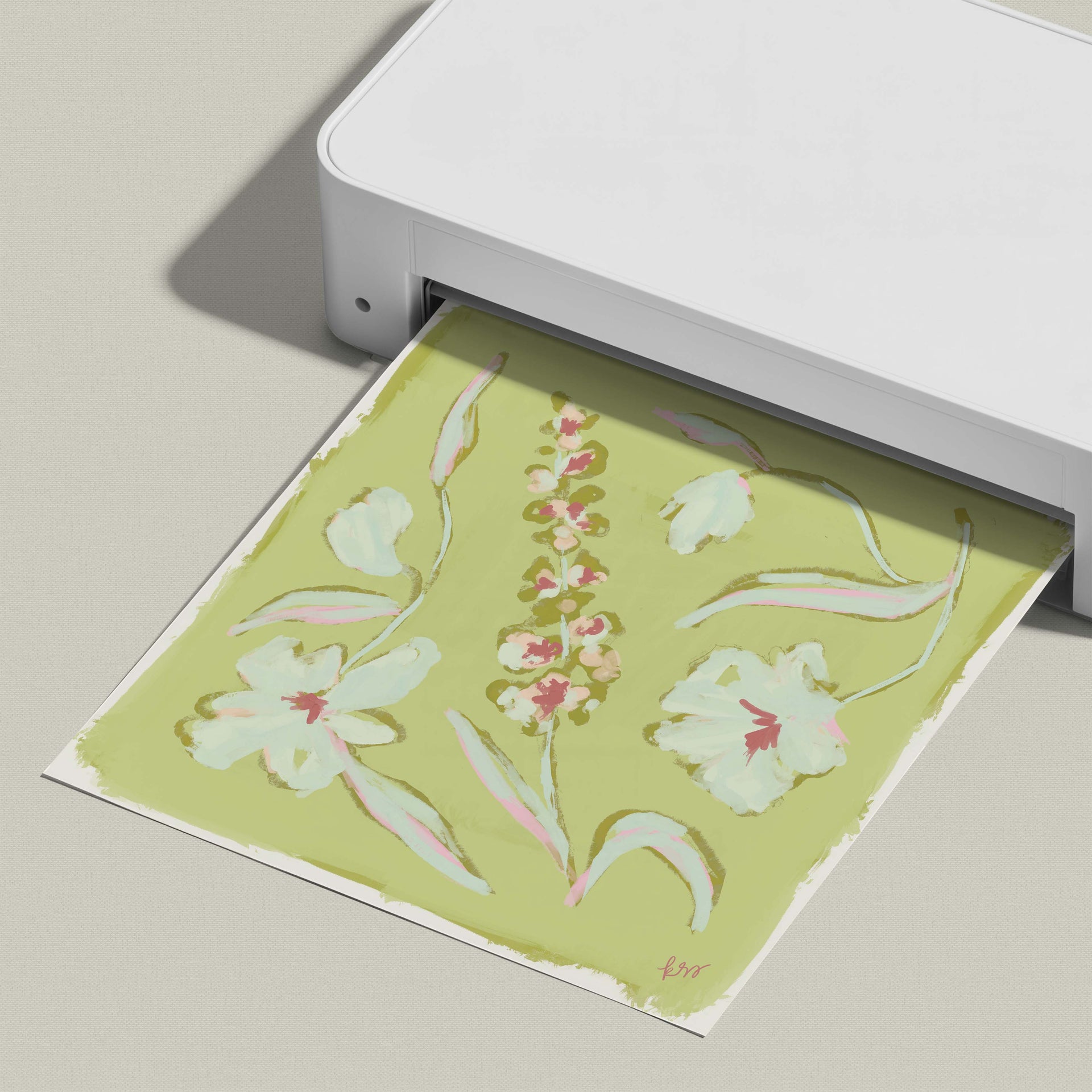 A white printer is printing a colorful floral design on a piece of paper.