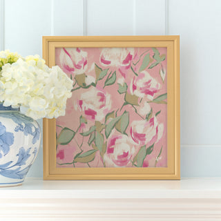 a framed painting of pink and white flowers on a white shelf, accompanied by a vase of white hydrangeas.