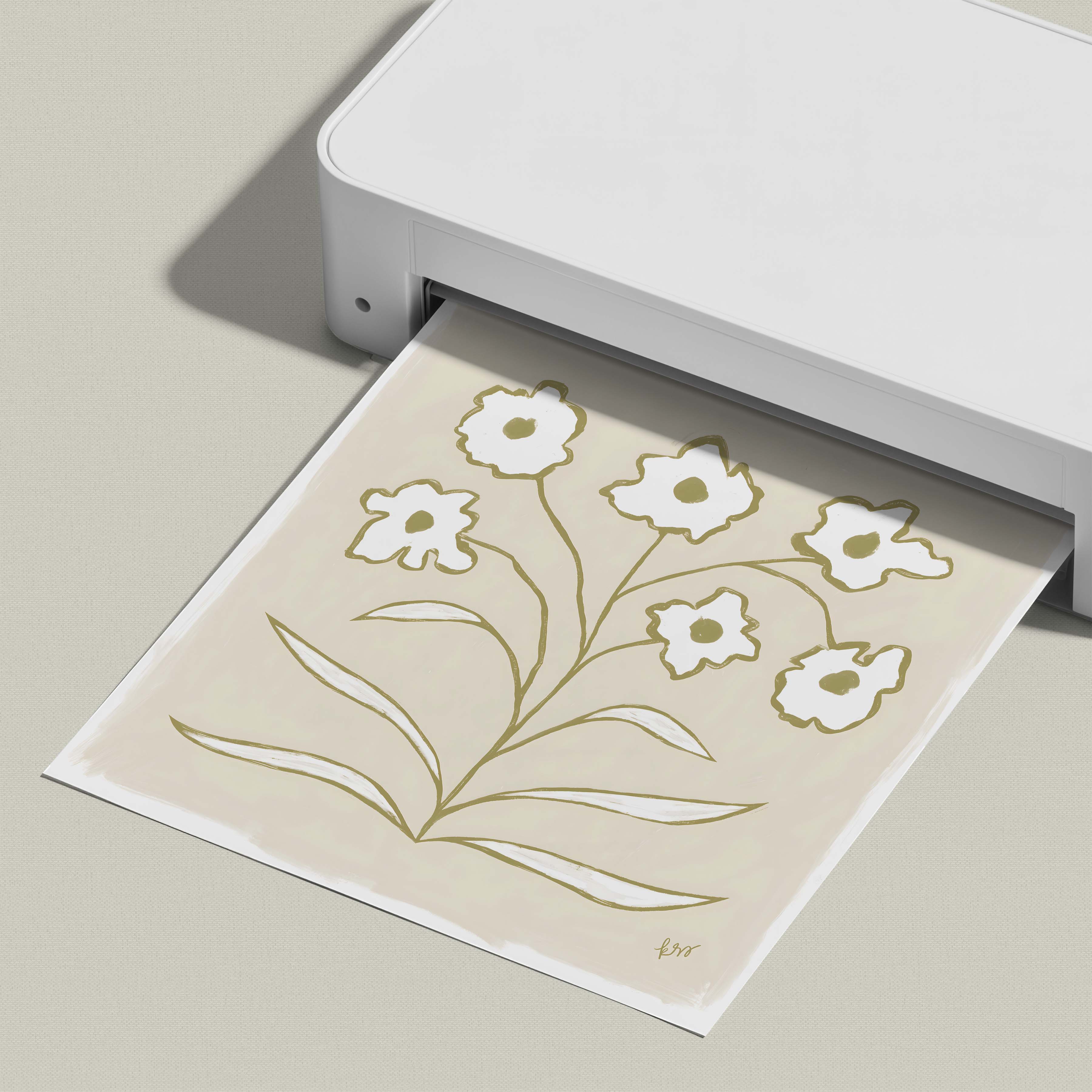 A white printer is printing a paper with a floral design on it.