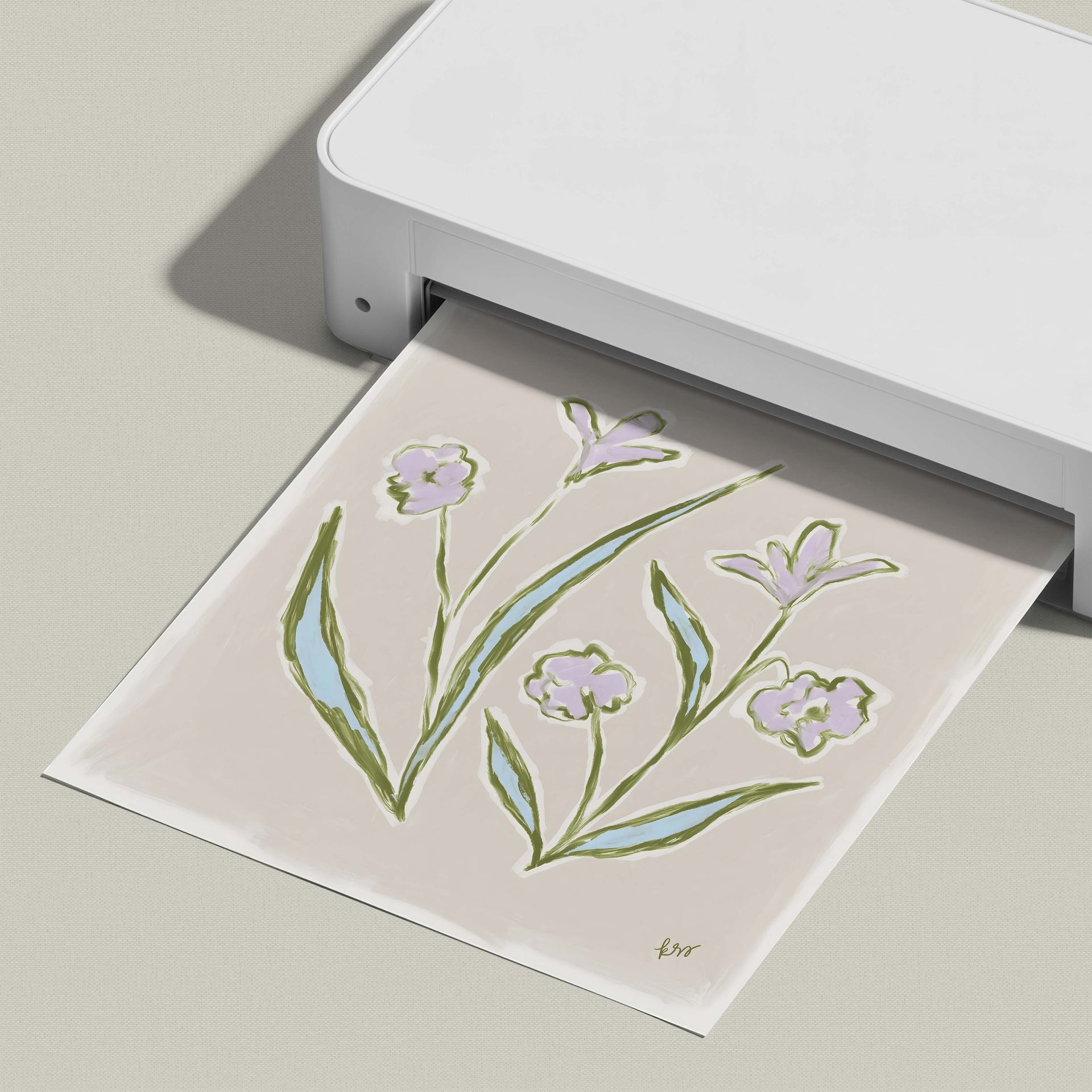 A white printer is printing a paper with a drawing of flowers on it.